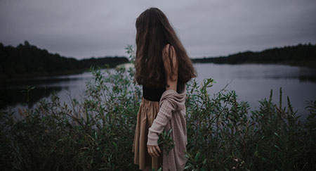 Caucasian woman standing near river