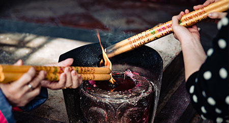 Lighting thick Chinese incense sticks
